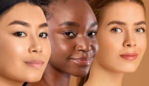 Three women, each with a unique skin type, standing side by side