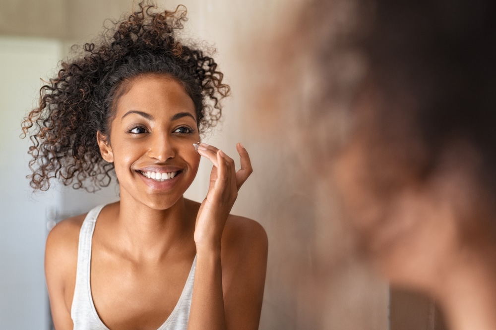 Woman putting on skincare after a chemical peel in Lubbock, TX